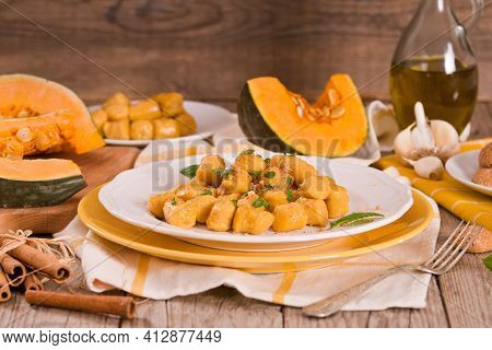 Pumpkin Gnocchi With Grated Amaretti Cookies On White Dish.