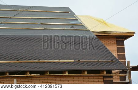 How To Install Asphalt Roof Shingles: A Close-up Of Asphalt Shingles Installation On The Roof Covere