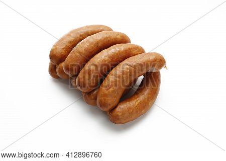 Country Style Smoked Sausage In Rings, Isolated On A White Background. Traditional Meat Sausage With