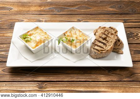 Two Servings Of Julienne With Grilled Ciabatta Slices