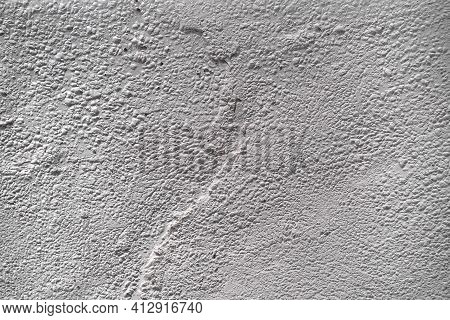 Textured Wall Stucco Background With Scratches, Scuffs And Stains. Uneven Plaster Backdrop Of White 