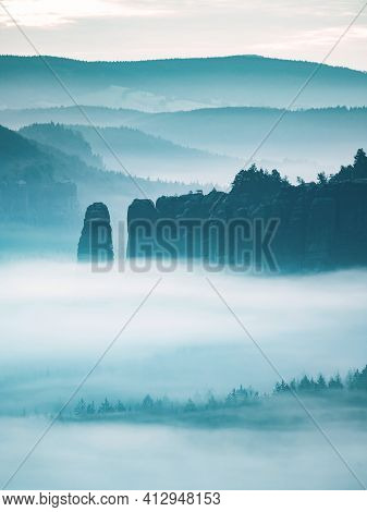 Mountain Peak Outline In Blue Night Mist.  Row Of Foggy Mountain Ranges In Sachsen Deutschland Park.