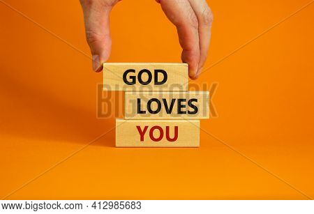 God Loves You Symbol. Concept Words 'god Loves You' On Wooden Blocks On A Beautiful Orange Backgroun