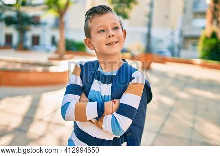 dorable caucasian student boy smiling happy standing at the park.