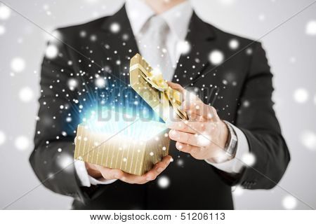love, romance, holiday, celebration concept - man opening gift box