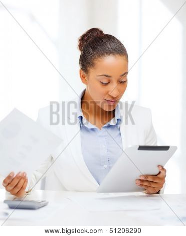 office, business, technology and internet concept - businesswoman with tablet pc in office