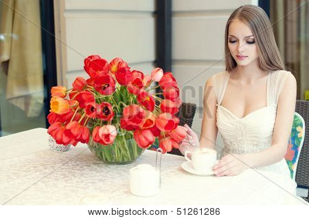 Portrait Of Young Pretty Woman Sitting In Restaurant