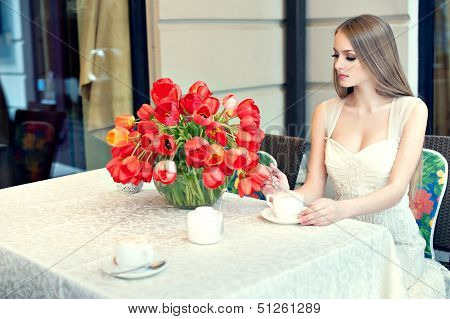 Portrait Of Young Pretty Woman Sitting In Restaurant