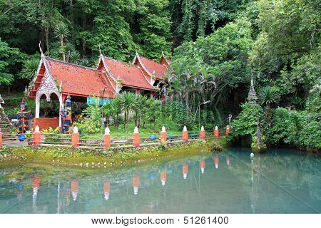 CHIANGMAI, THAILAND - JUNE 2012 : Main entrance at Chiangdao Cave surrounded by green fish pond at Doi Chung mountain on June 16, 2012 in Chiangmai, Thailand