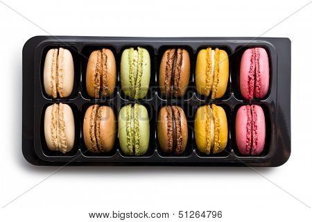 colorful macaroons in plastick box on white background