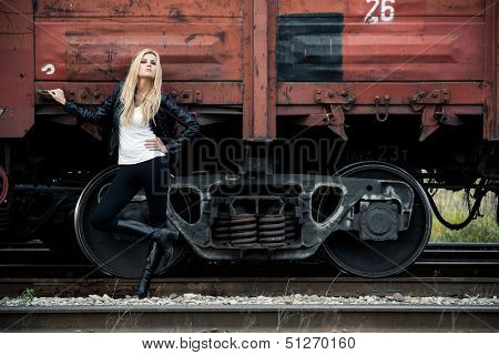 Young woman standing near a train
