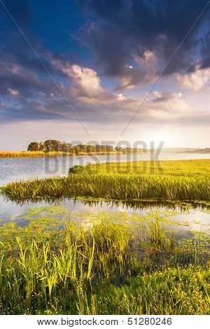 Beautiful view of sinuous river in summer. Dramatic overcast sky. Southern Buh River, Ukraine, Europe. Beauty world.