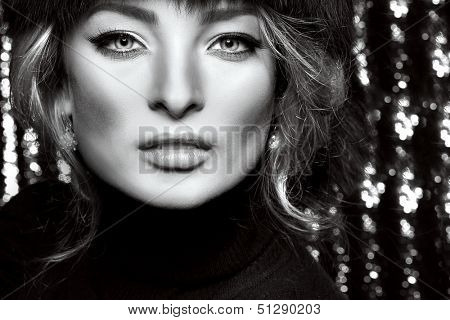 Portrait of beautiful sexual blonde in a fur cap 