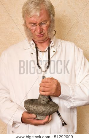 Vintage pharmacist preparing medication with mortar and pestle