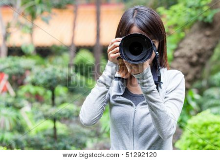 Female photographer takes photo