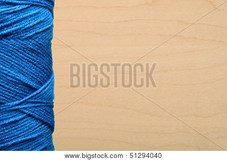 Blue Yarn On Wood Background