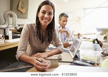 Two Architects Making Models In Office Using Digital Tablet