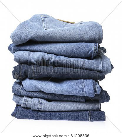 Stack of blue jeans on white background