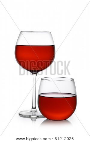 Red wine in traditional and stemless glasses cutout, isolated on white background