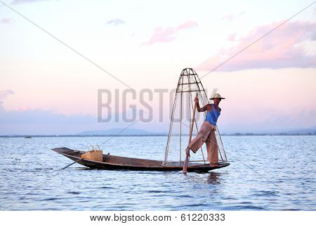 INLE LAKE, MYANMAR DECEMBER 12, 2013: Fishermen at Inle Lake, Shan State, Myanmar Intha people possess the leg-rowing style and the unique coop-like fishing equipment