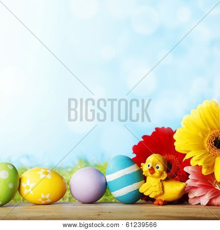 Easter eggs, flowers and chick aber green grass background