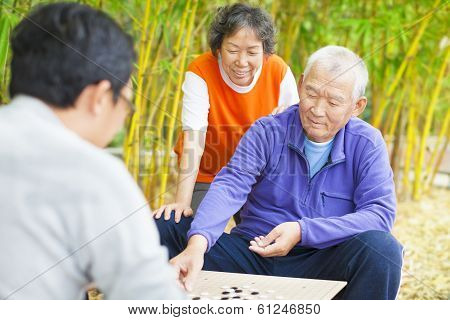 Seniors Play Traditional Chinese Board Game Go