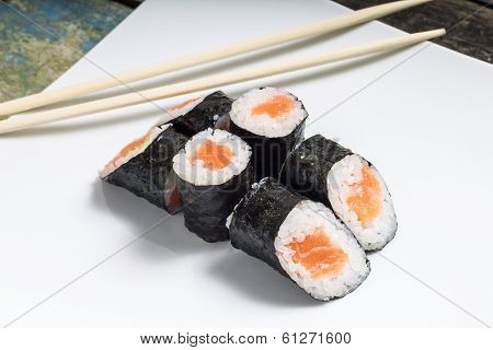 Makisushi On White Plate. Seafood Traditional Maki Sushi Rolls With Chopsticks