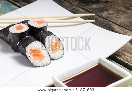 Makisushi On White Plate. Seafood Traditional Maki Sushi Rolls With Chopsticks
