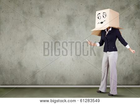 Businesswoman using mobile phone wearing carton box on head