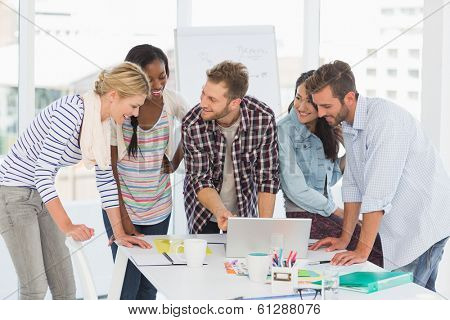 Smiling team of designers having a meeting in creative office