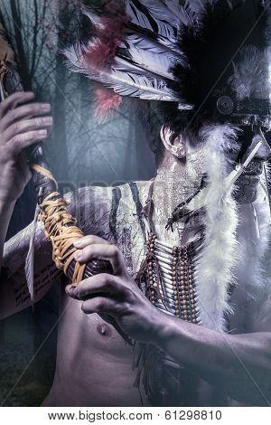American Indian warrior, chief of the tribe. man with feather headdress and tomahawk