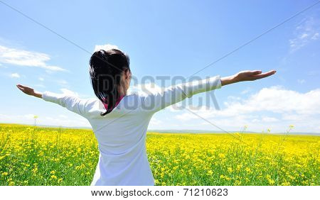 cheering woman open arms at cole flower field