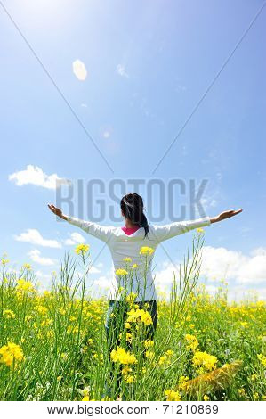 cheering woman open arms at cole flower field