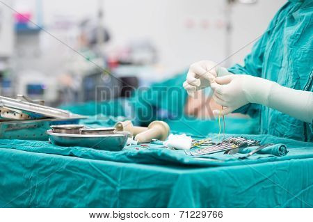 Scrub Nurse Preparing Tools For Operation