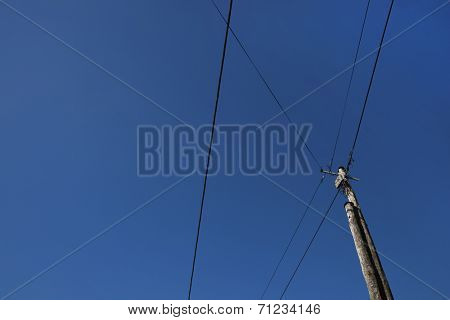 Low angle view of electric wires against clear blue sky