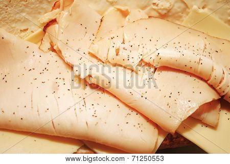 Close Up Of Peppered Turkey Deli Meat On A Sandwich