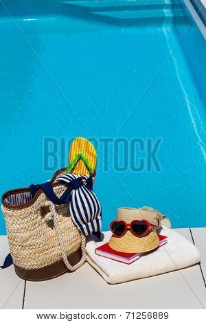 utensils for a nice and relaxing vacation day lying next to a swimming pool. relaxation on holiday.