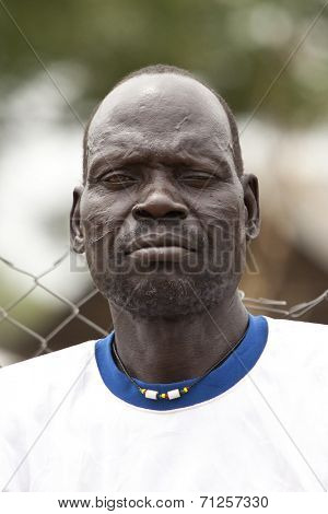 TORIT, SOUTH SUDAN-FEBRUARY 21 2013: Unidentified man with tribal scarification in the town of Torit, South Sudan