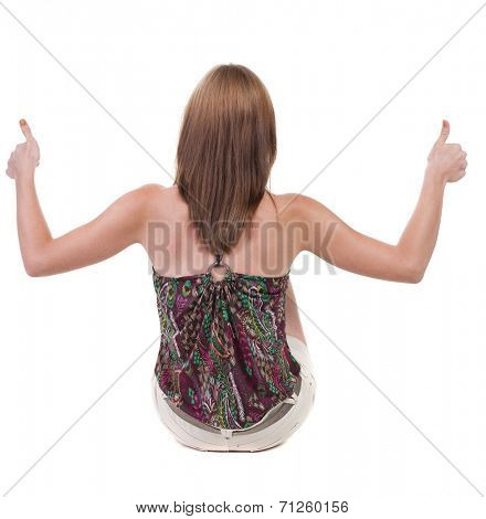 back view of siting young blonde  woman showing thumb up.  Rear view people collection.  backside view of person.  Isolated over white background