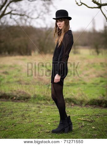 Beautiful Young Woman Dressed In Black Wearing Bowler Hat
