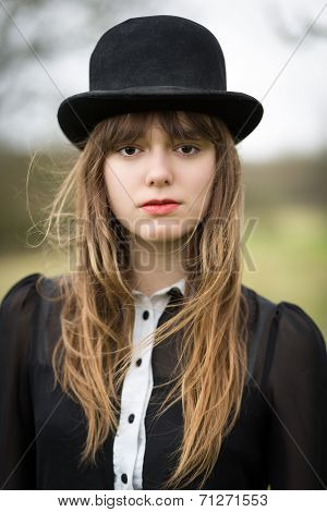 Beautiful Young Woman Dressed In Black Wearing Bowler Hat
