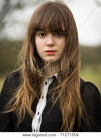 Beautiful Young Woman Dressed In Black In A Field