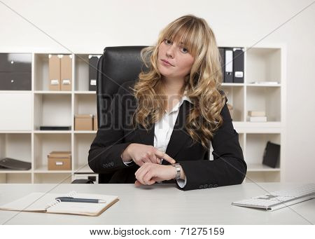 Manageress Pointing To Her Watch