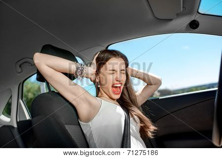Young Sad Woman Shouts Holding His Head Standing In The Car In The Traffic