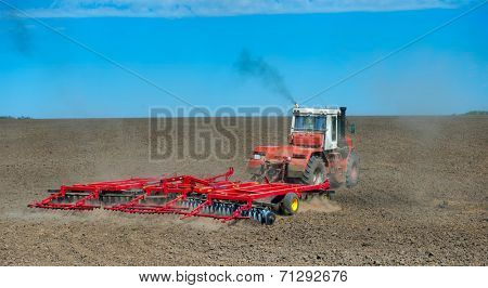 tractor in a field plowing