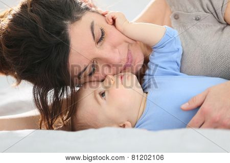 Portrait of mother cuddling baby boy
