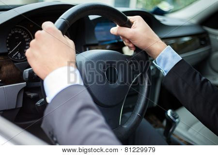 Close-up of hands on a steering wheel