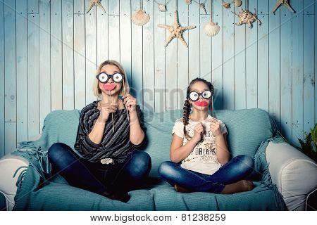 Mom and daughter with false mustaches