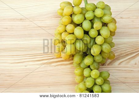 Bunch Of Ripe Grapes On A Wood Background