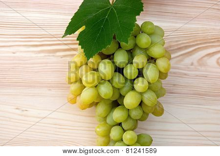 Bunch Of Ripe Grapes On A Wood Background